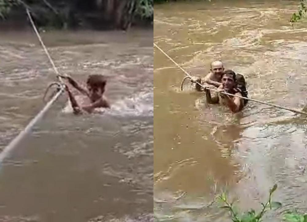 VIDEO: Estudantes atravessam rio com auxílio de corda para irem a escola após chuvas em Milton Brandão